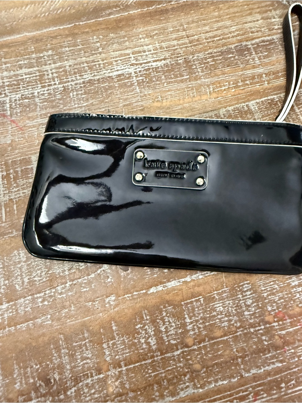 Kate Spade Black Patent Leather Zip Wristlet, 8 1/2” x 4 1/2”.